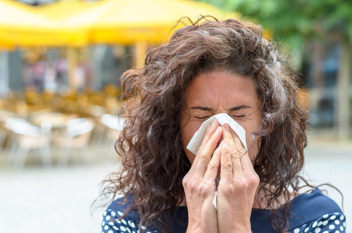 Woman Sneezing Outdoors