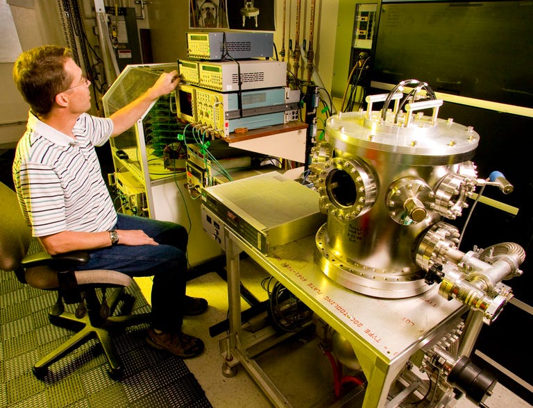 Lawrence Livermore Lab electrical engineer Jim Watson tests the compact proton source.