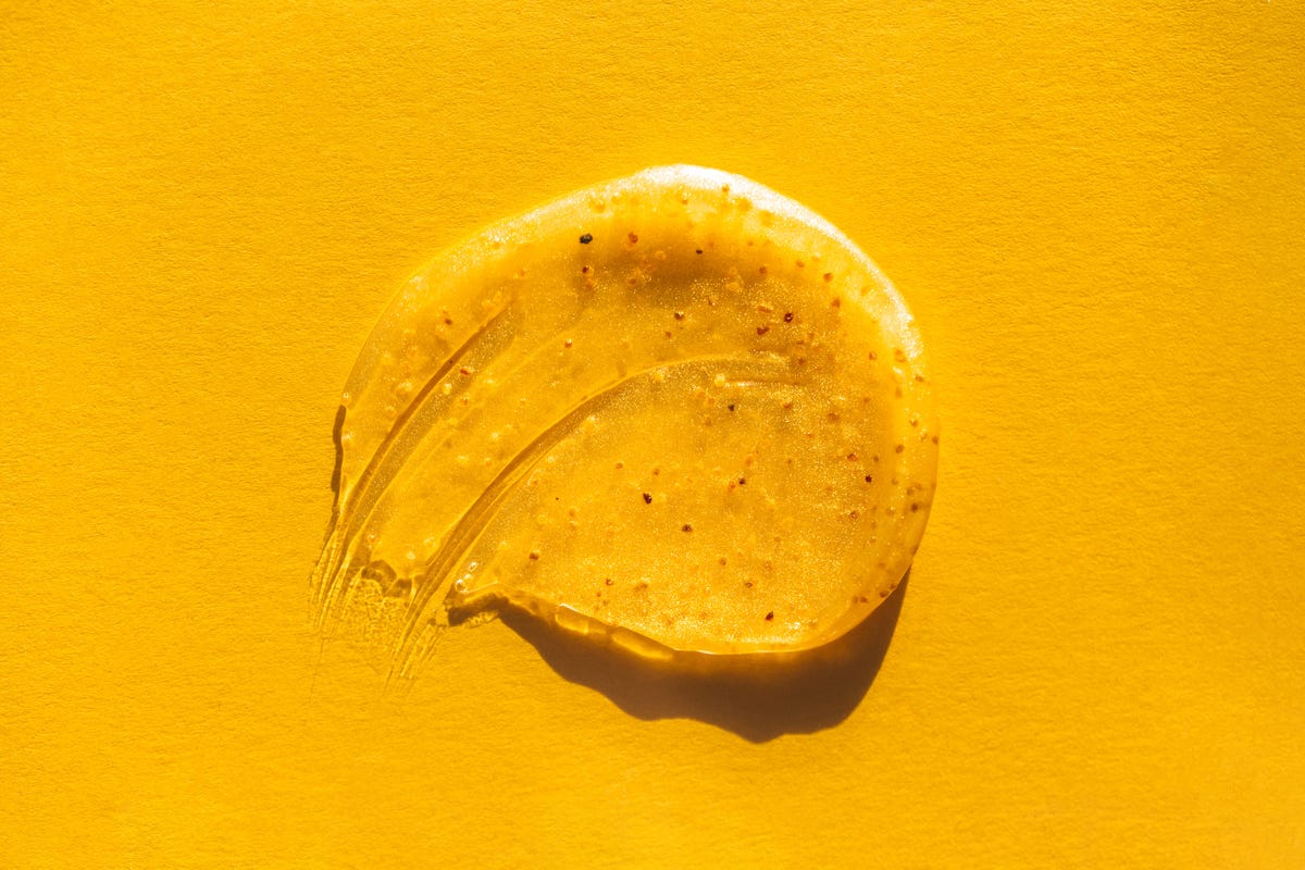 Smear of exfoliating scrub on a yellow background