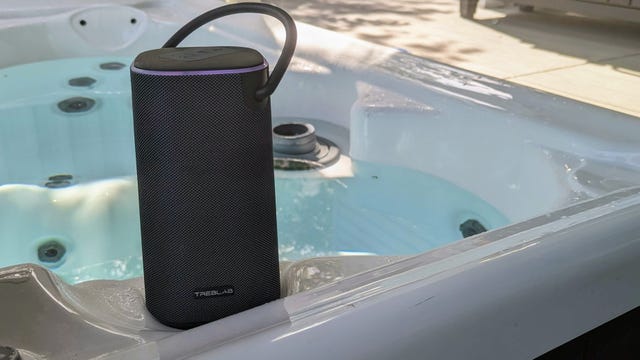 Bluetooth speaker sat on the side of a hot tub