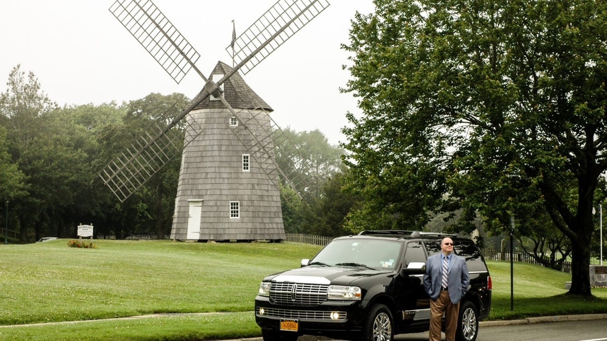 An Uber SUV sits near East Hampton's Old Hook Windmill