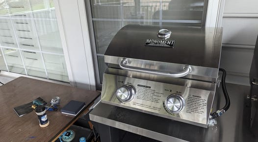 Small silver grill on a metal table