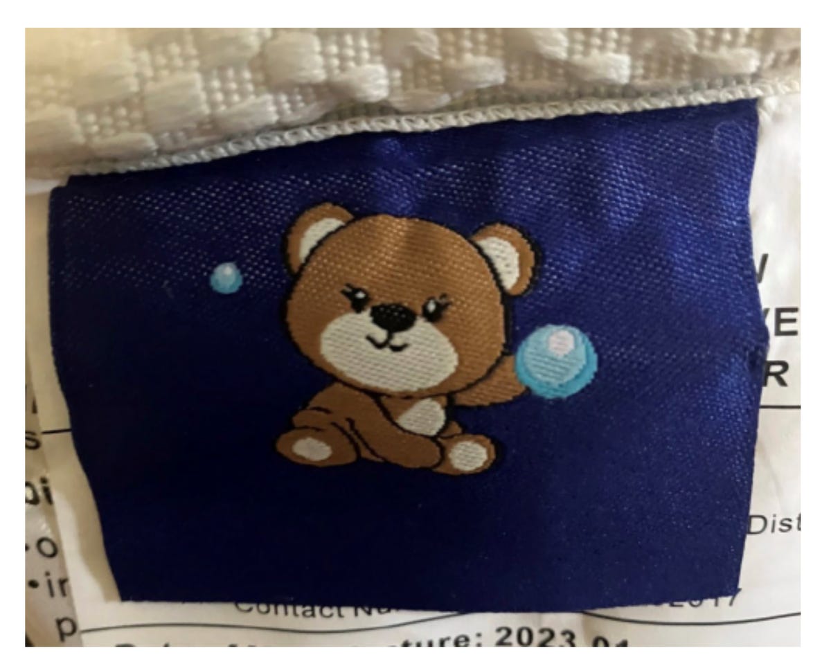 A blue tag with a teddy bear on it