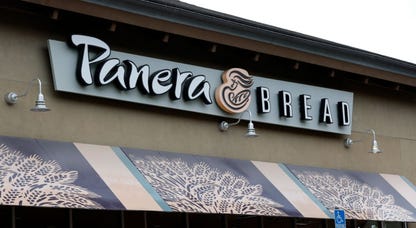 sign is posted on the exterior of a Panera Bread restaurant