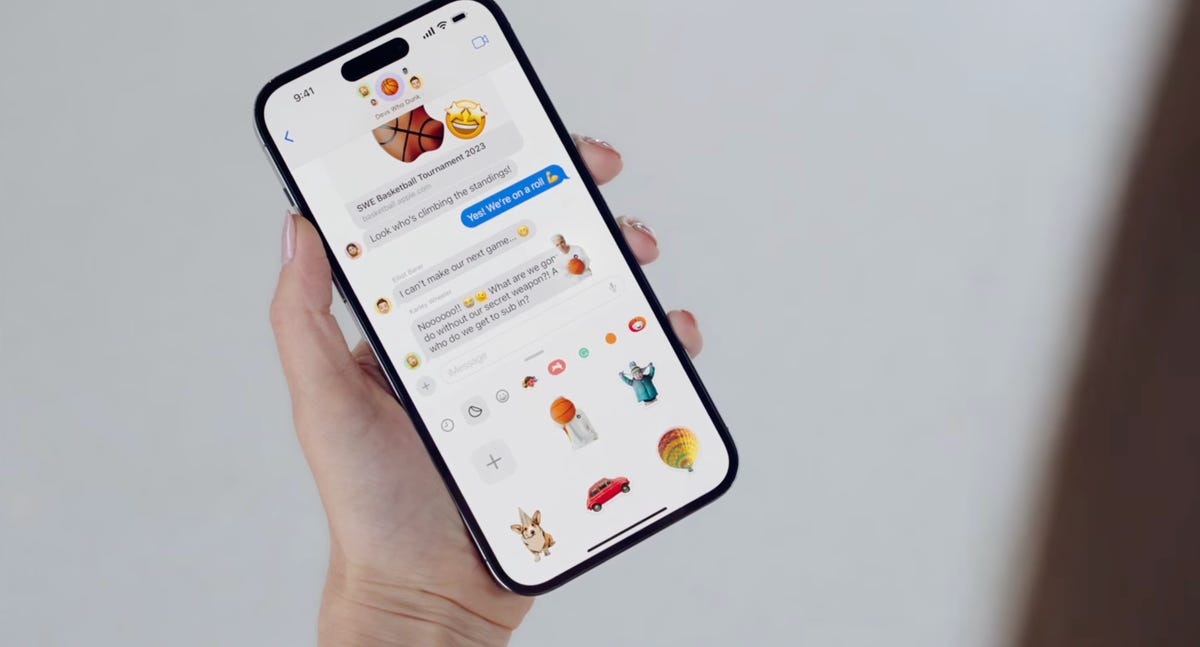An iPhone with the Stickers drawer in Messages open