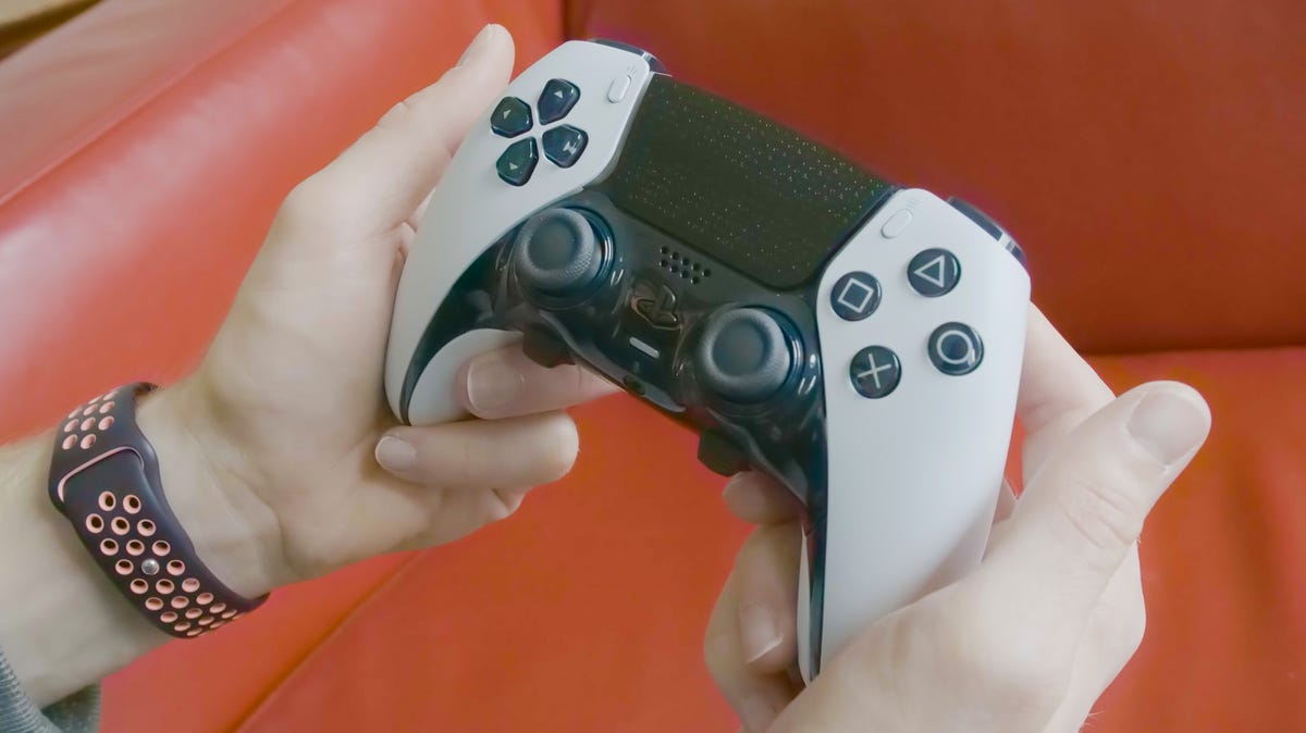 two hands hold a Sony DualSense Edge controller 