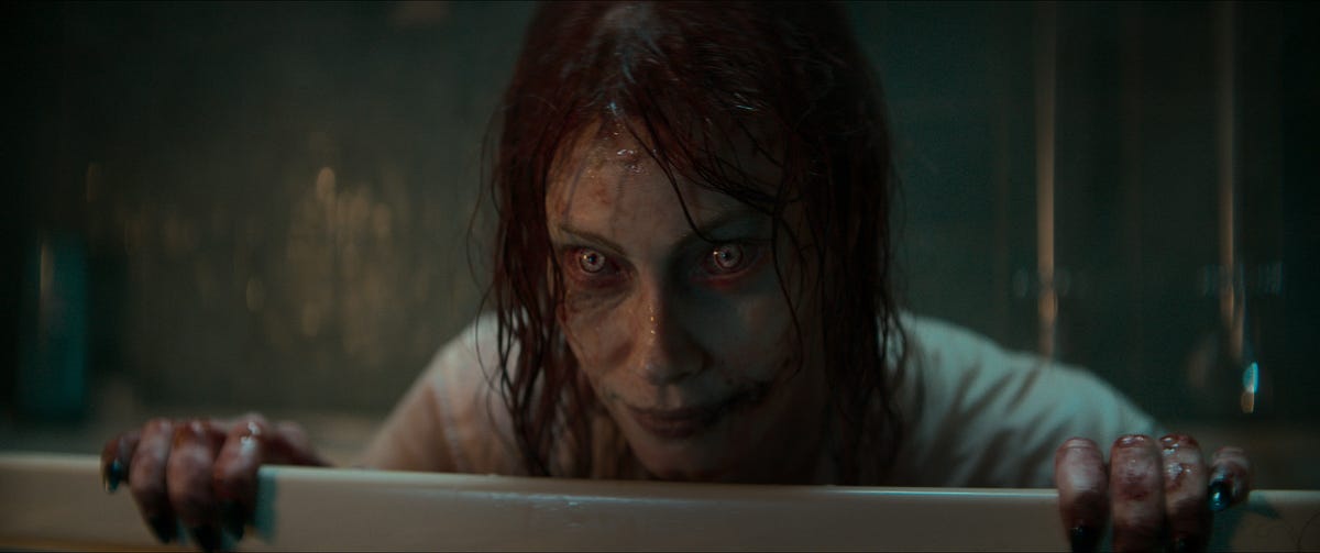 Alyssa Sutherland as a demonic figure rising from a bath in Evil Dead Rise.