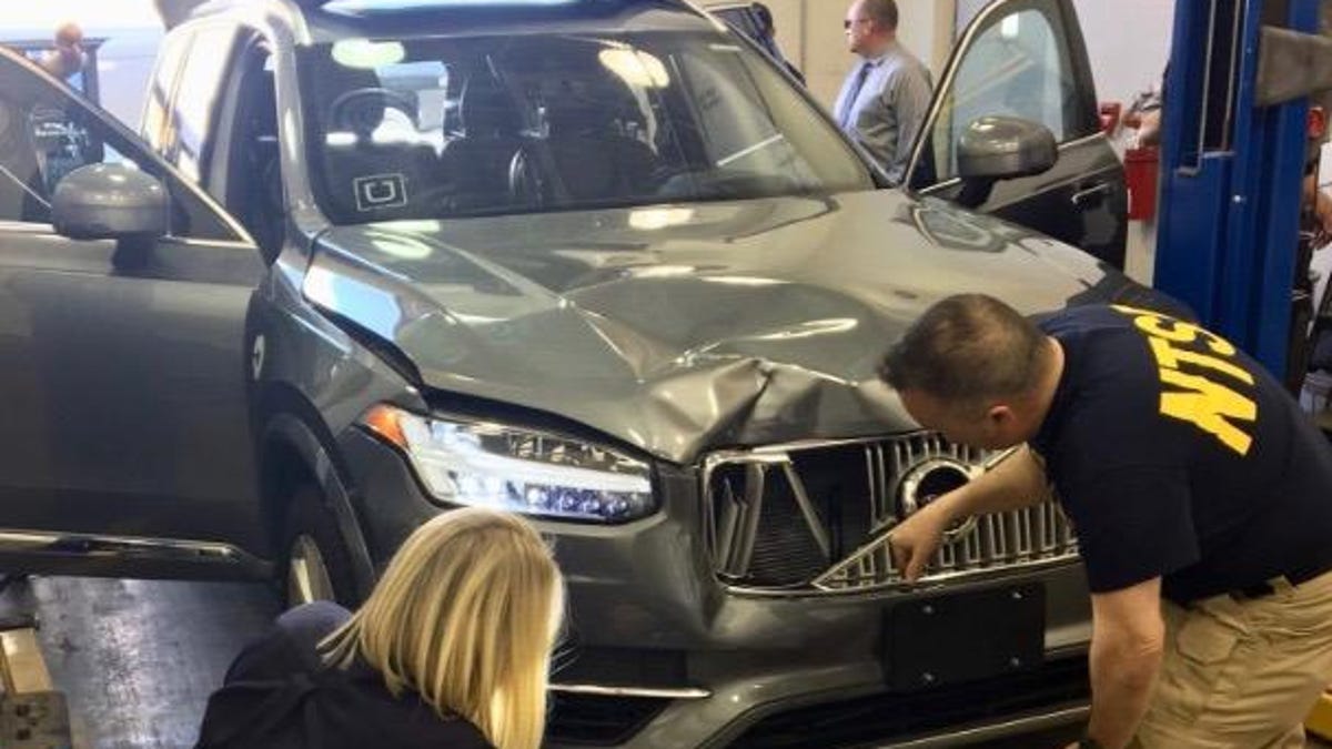 NTSB investigators examine Uber vehicle involved in a fatal accident in Tempe, Arizona.