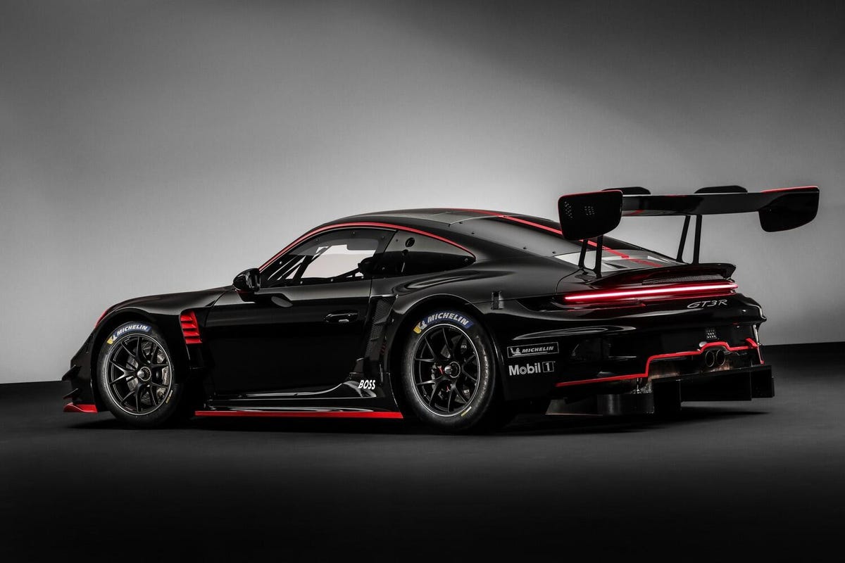 The 2022 Porsche 911 GT3 R, looking moody in black with red trim and a giant wing hanging off the back.