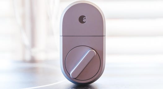 The August Smart Lock sitting upright on a table.
