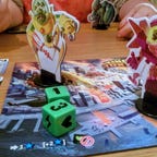 Two Kaiju rampaging across tokyo in board game form