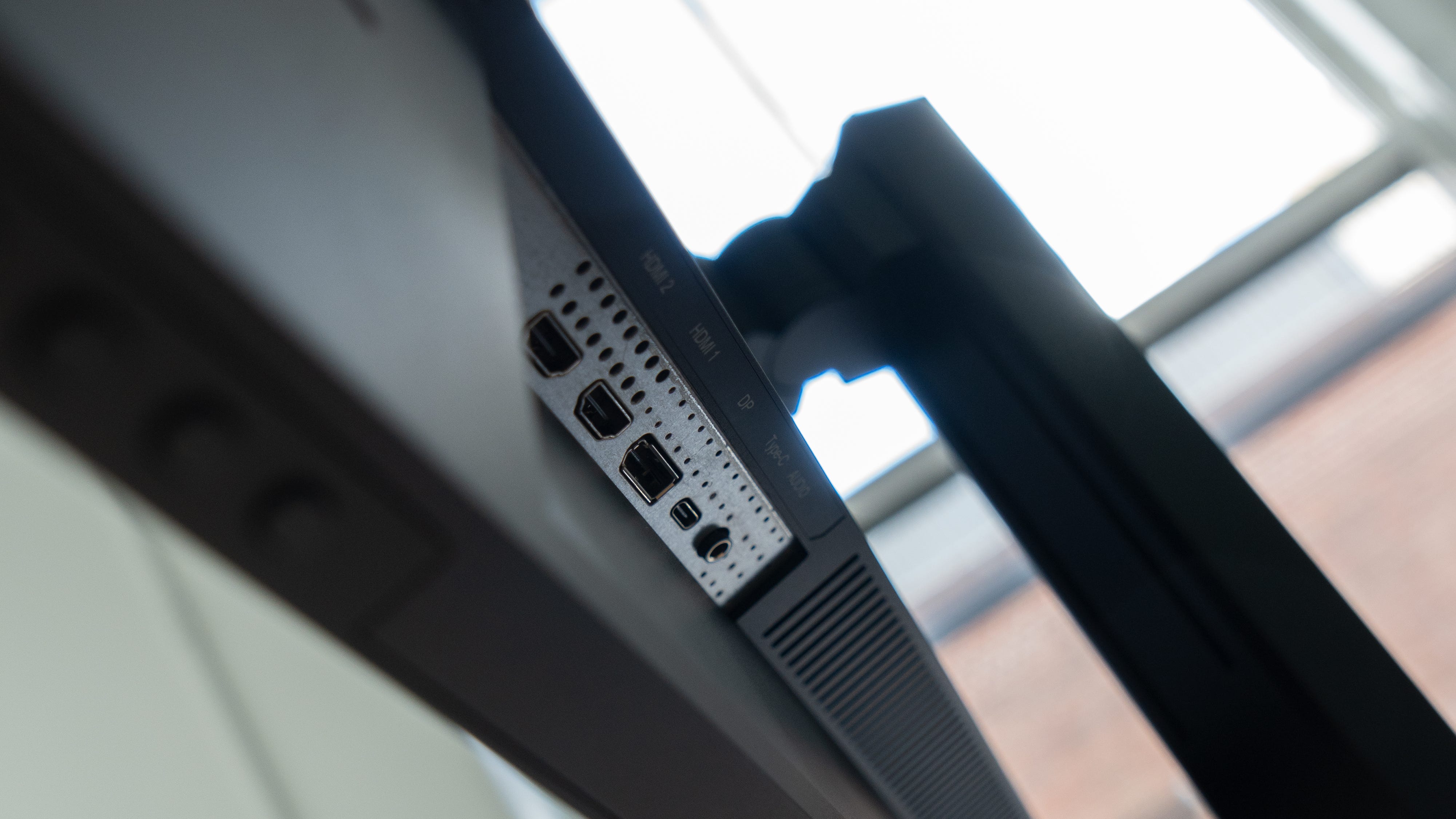 A close-up of the two HDMI, DisplayPort and USB-C connectors on the Innocn 40C1R, shot from below with a window in the background
