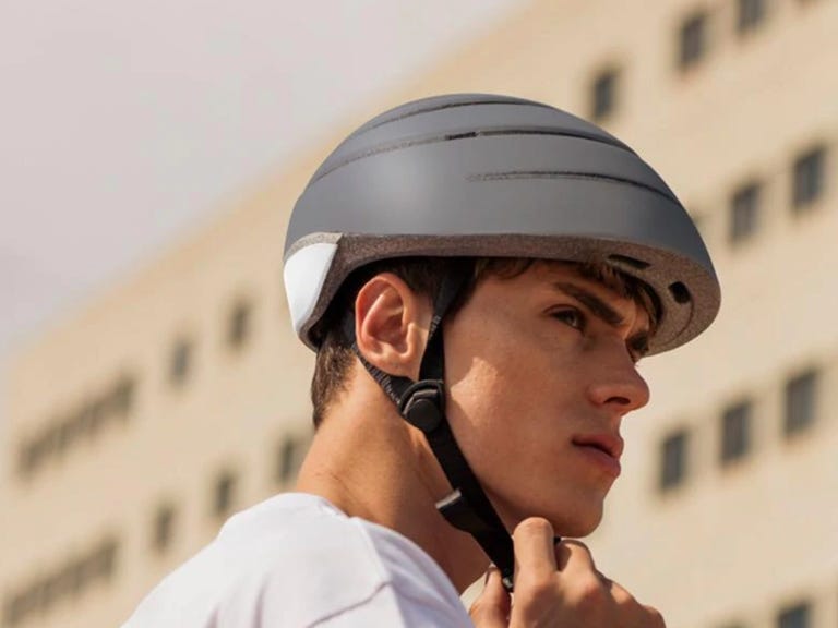 wearing foldable gray bike helmet