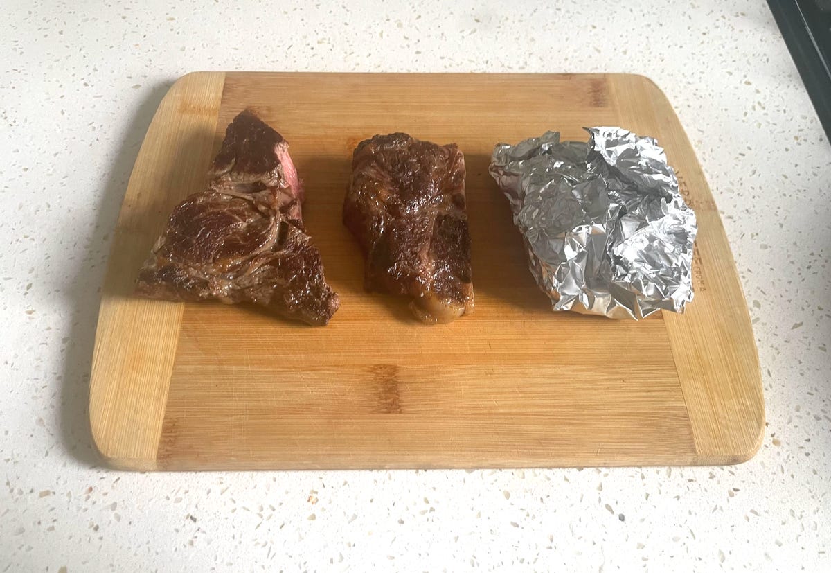 three pieces of leftover steak on a cutting board