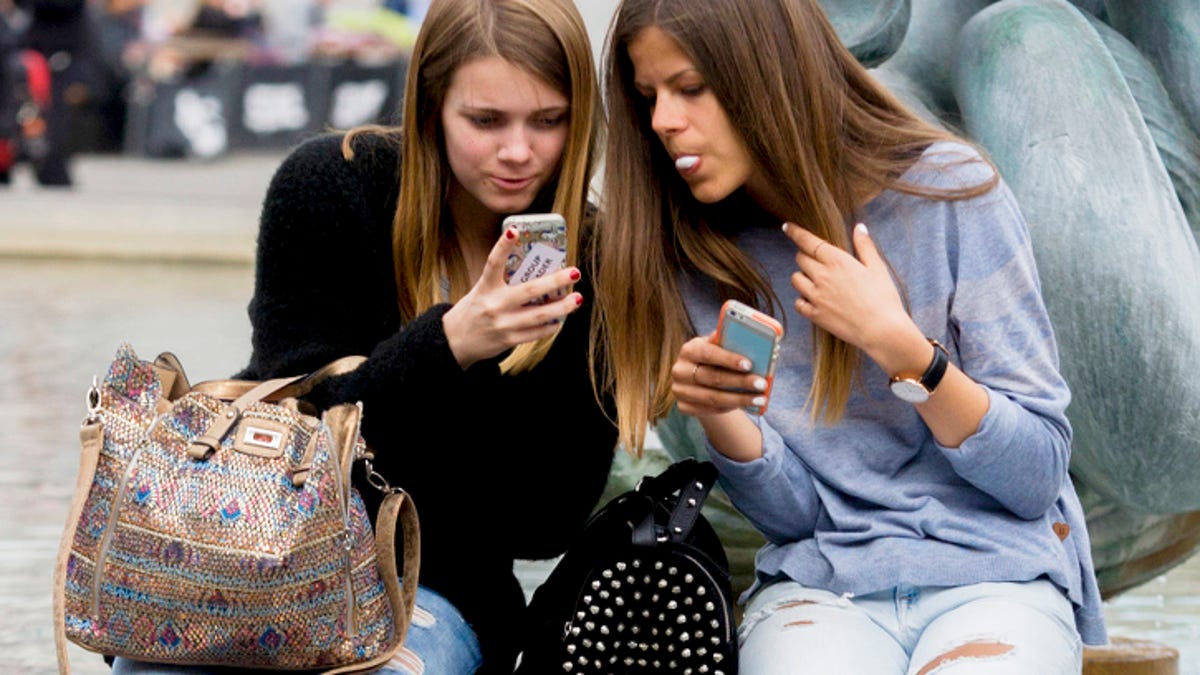 Teenage girls on their smartphones.