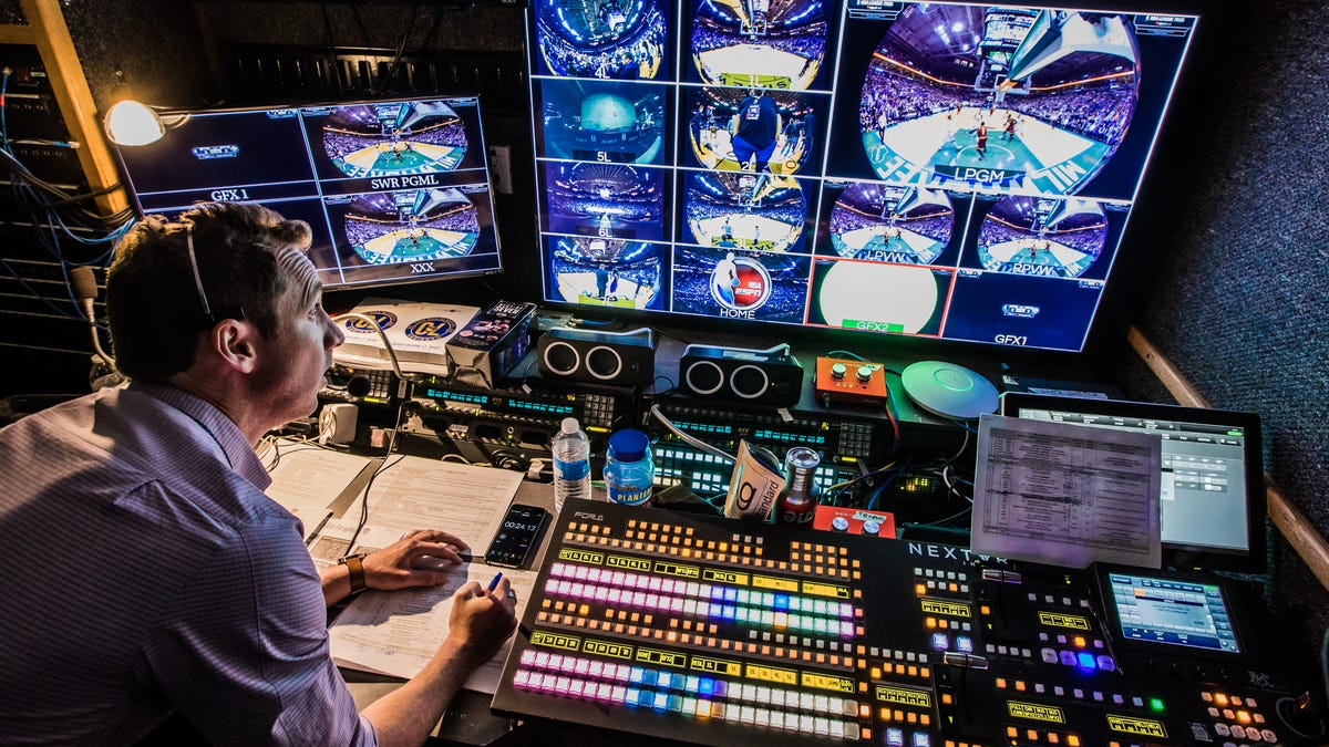 A technician makes last-minute preparations inside NextVR's production truck prior to the company's broadcast of a Warriors-Timberwolves game.