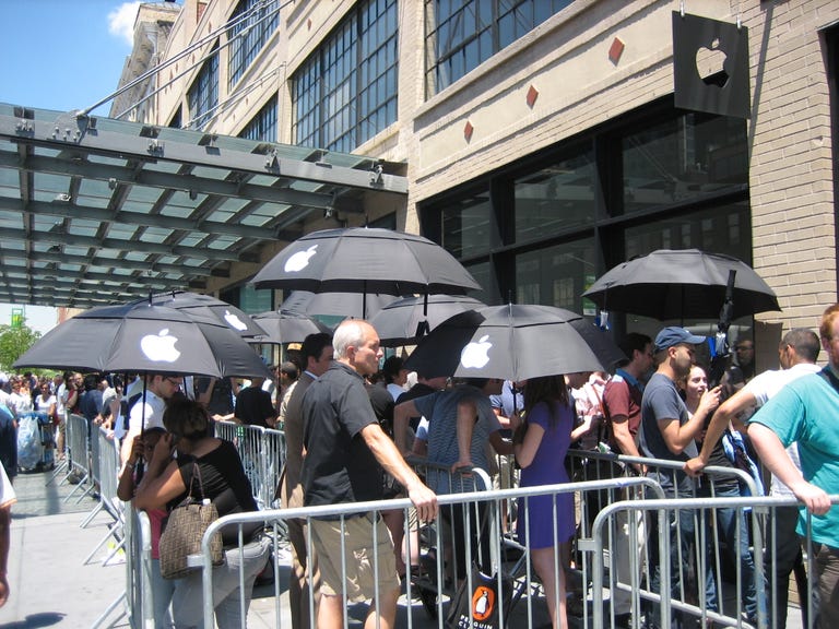 People have been waiting six hours to get the new iPhone 3G at the Apple store on West 14th Street in Manhattan. The line just goes on and on and on. Lucky line waiters are given Apple umbrellas to accompany free SmartWater bottles. At 86 degrees, it's not the hottest day on record, but in the blazing sun, it's certainly hot enough.