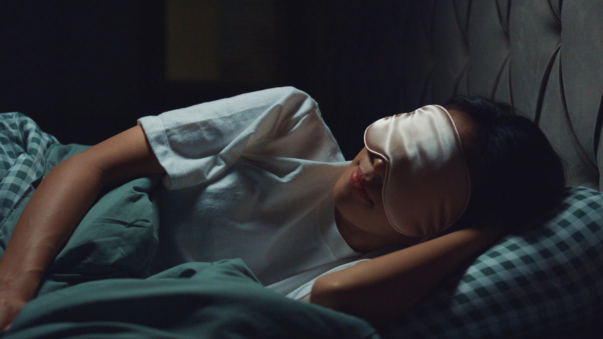 woman sleeping at night with an eye mask
