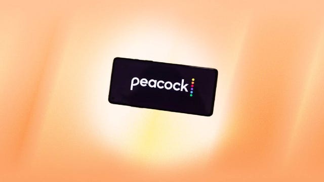 A phone displaying the Peacock logo against an orange background.