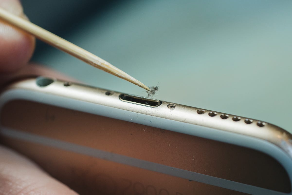 Close up on dirt removed from an iPhone's charging port