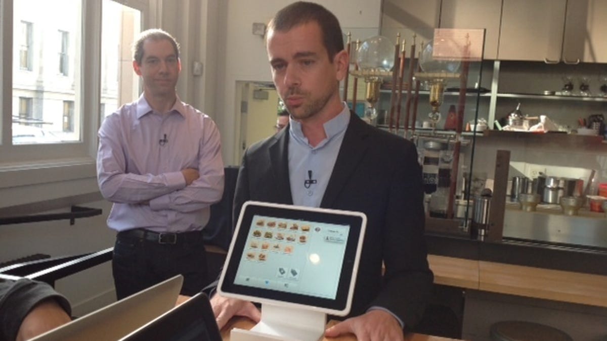 Square CEO Jack Dorsey shows off a Square product.