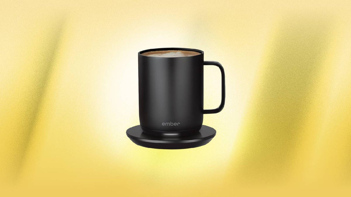 A black Ember smart mug and coaster against a yellow background.