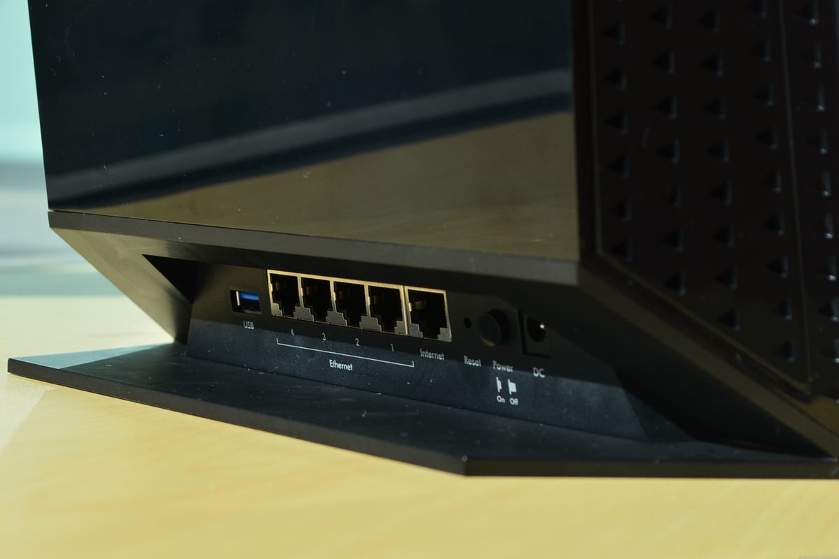 The base and the bulky part of the drive bay make it hard to reach the router's ports on the back.