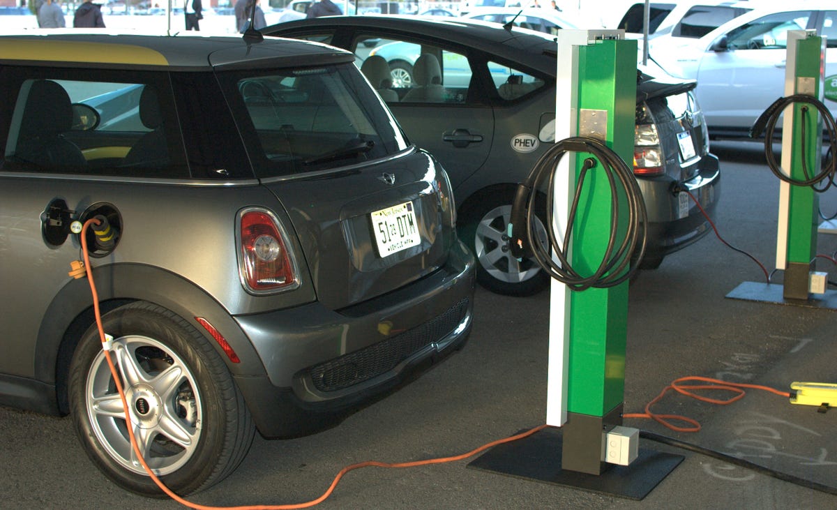An electric mini and a plug-in Prius charge up.