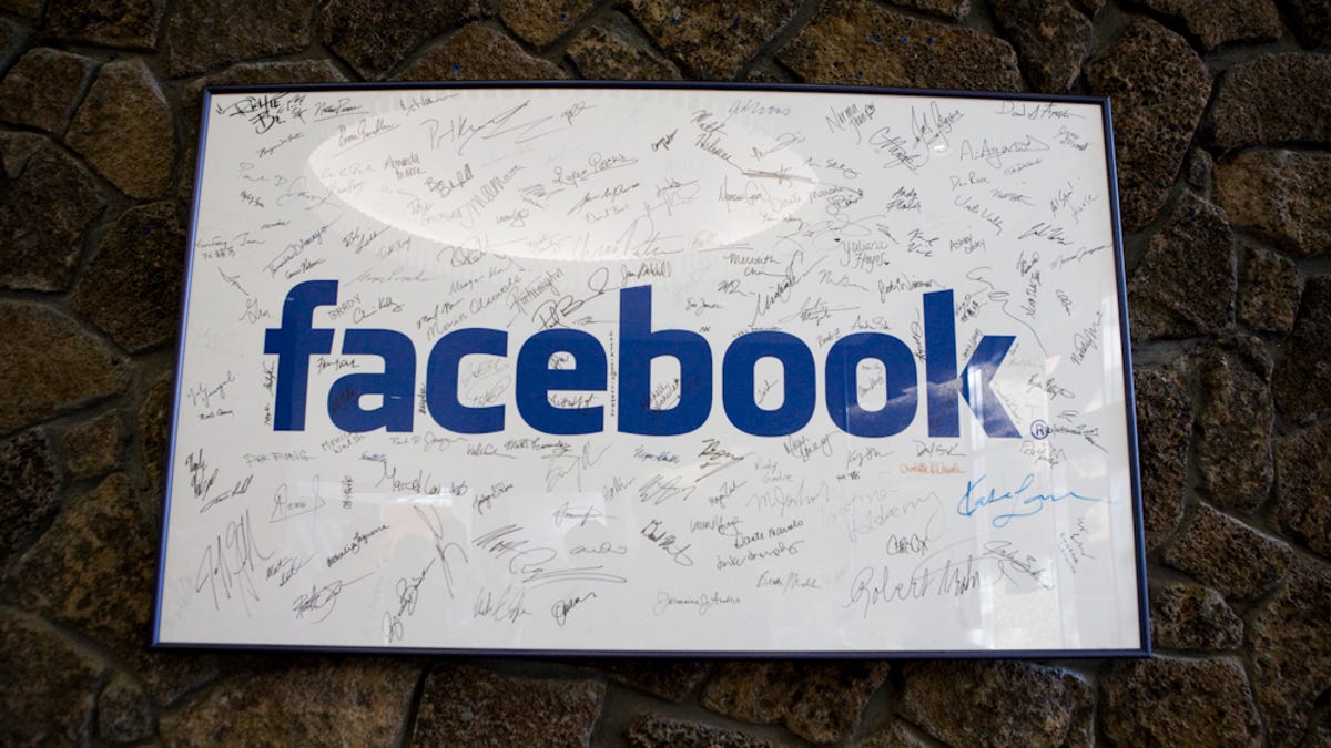A framed Facebook logo, filled with employees' signatures, hangs in the lobby of the company's Palo Alto, Calif., building in June 2009.
