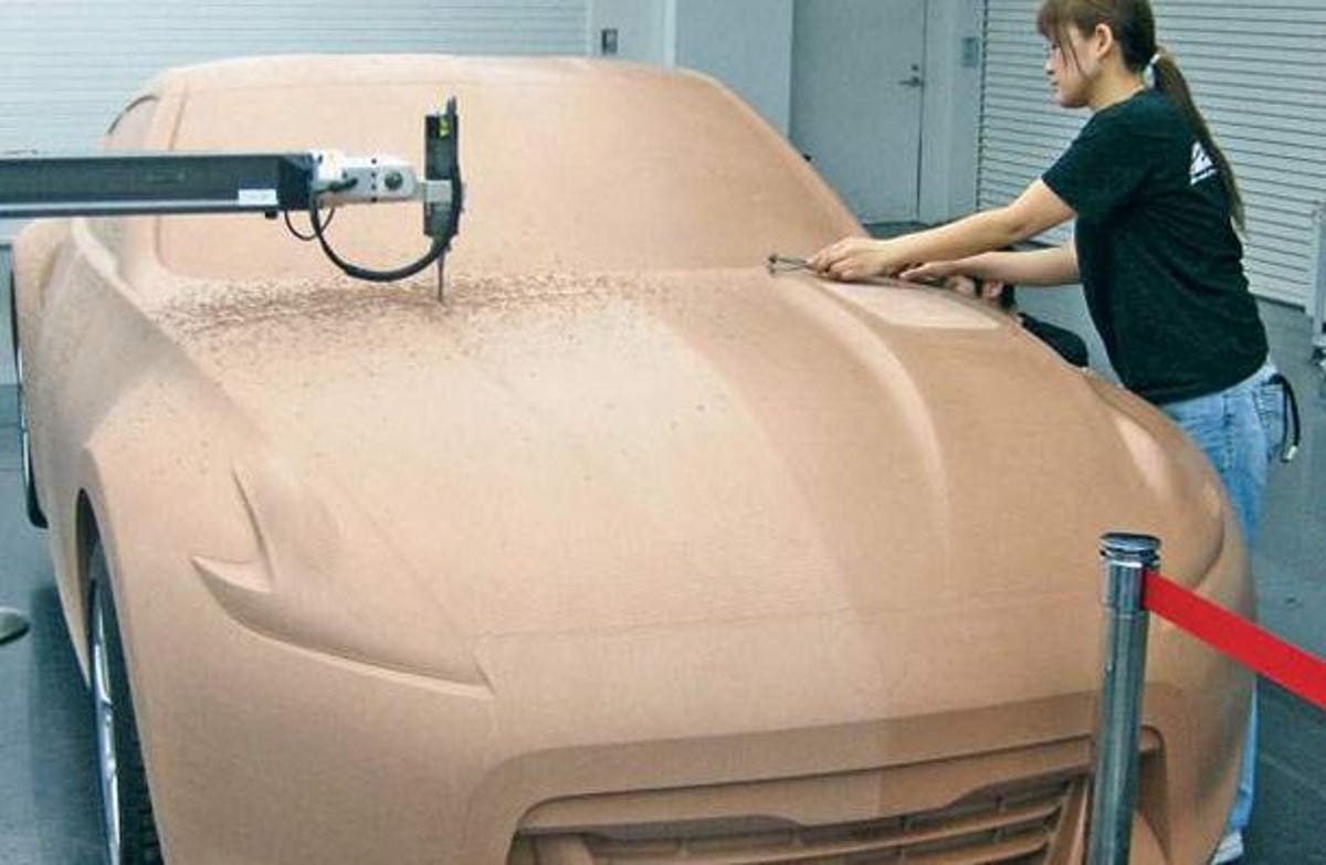 Designers work on a clay model of the Nissan Z