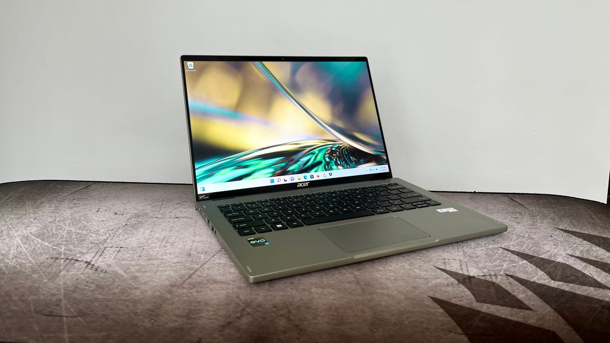 Acer Spin 5 2-in-1 laptop at an angle against a gray wall