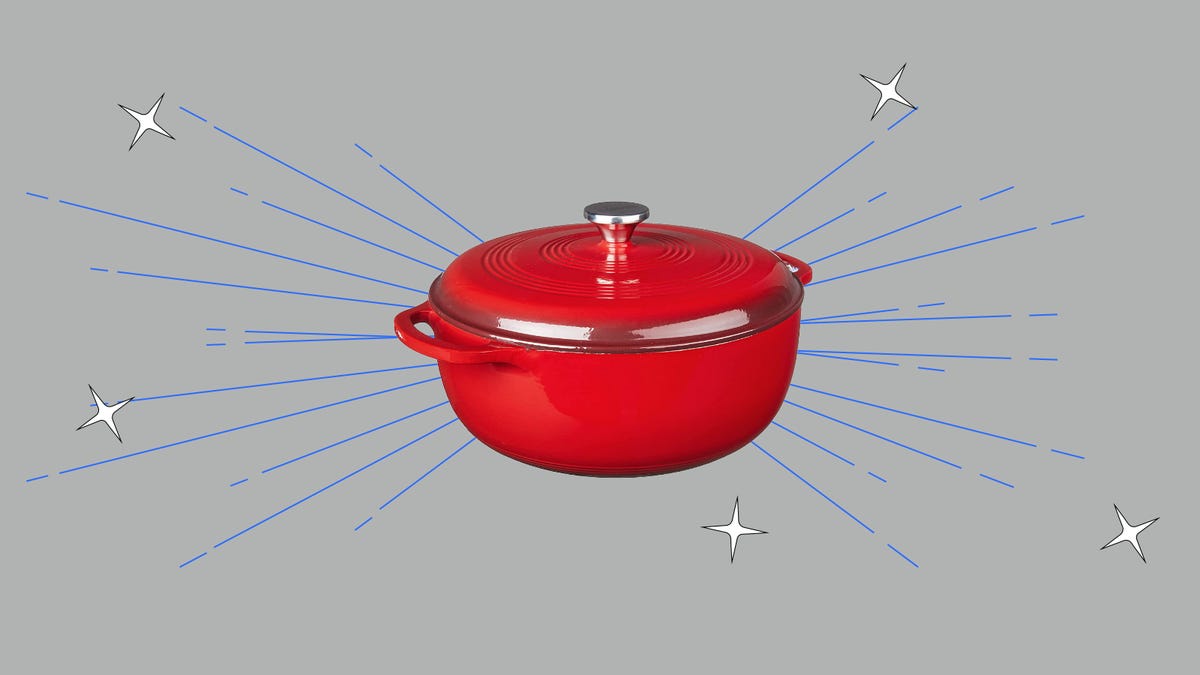 A red Dutch oven on a gray background
