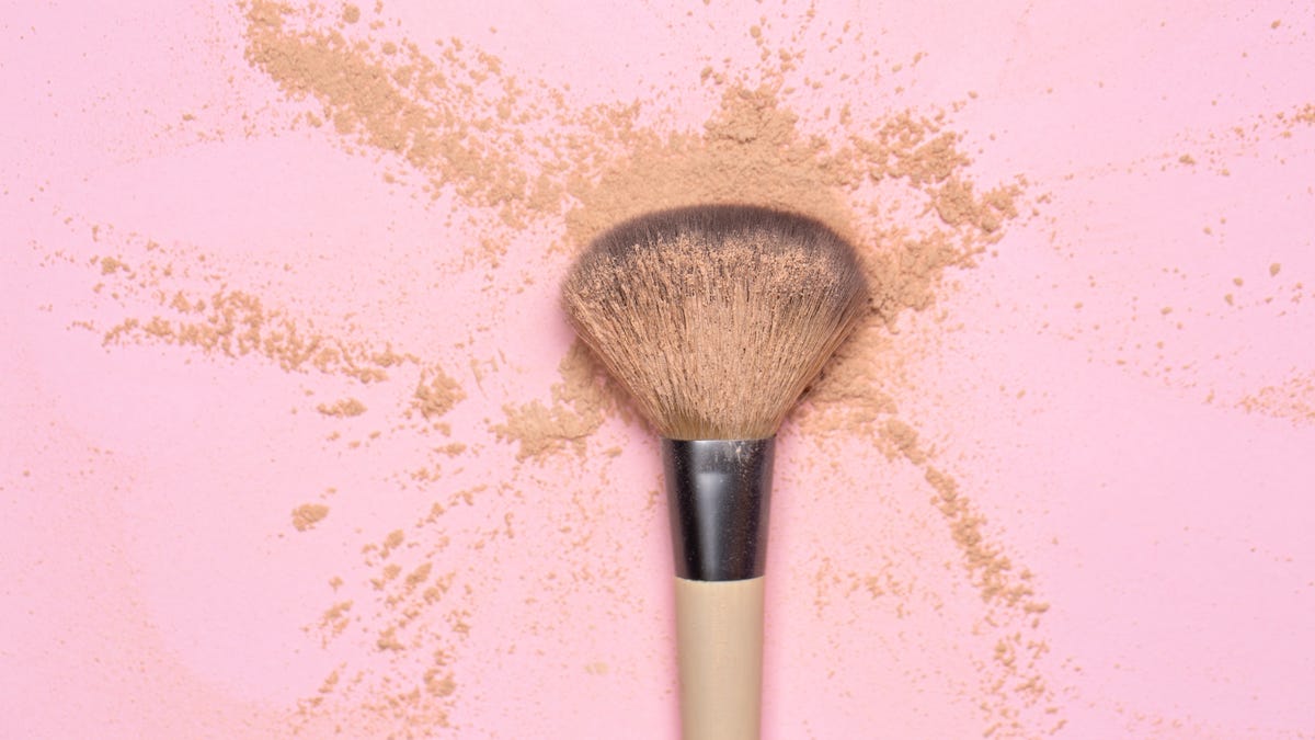 makeup brush covered with powder