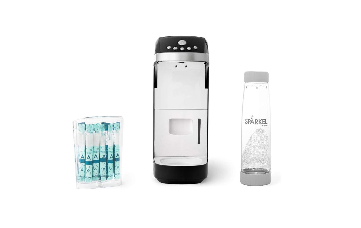 sodastream e terra on table with glass of soda water