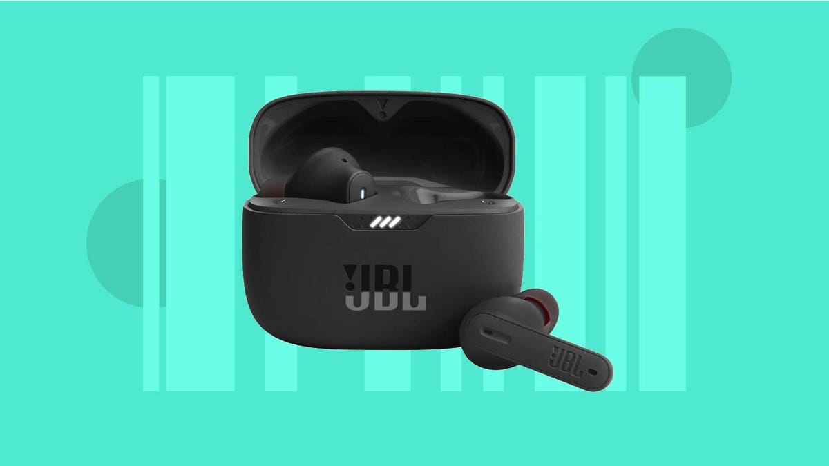 A pair of black JBL earbuds against a green background.
