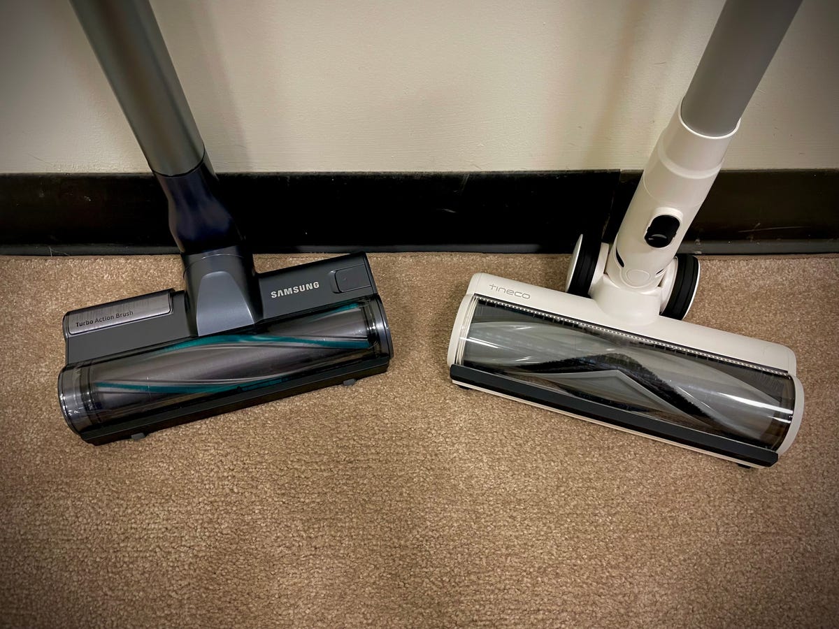 The brushrolls of the Samsung Jet 90 and Tineco Pure One S11 cordless vacuums sit side-by-side on a test carpet at the CNET product-testing lab.