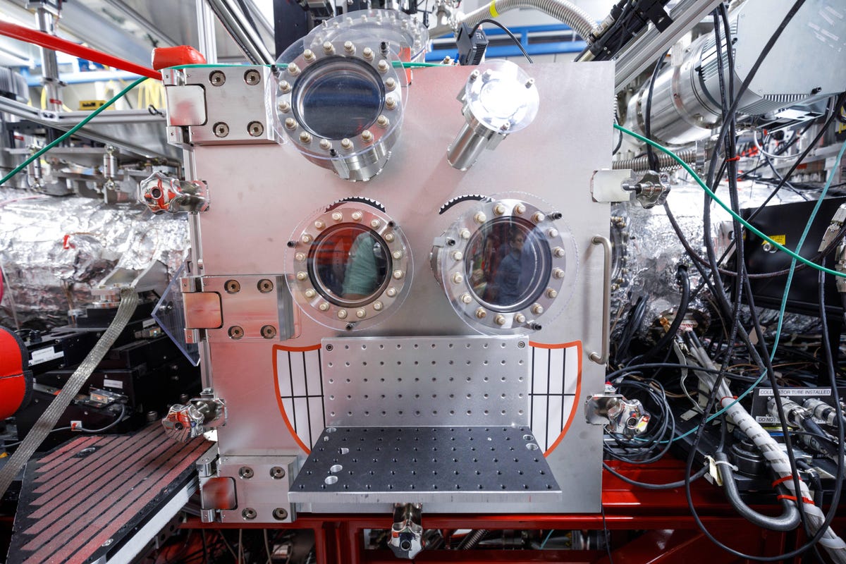 This chamber, a vacuum that seals out air, holds samples probed by SLAC's Coherent X-ray Imaging (CXI) experiment station. It's mostly used to study protein crystals. Yes, somebody turned two of the observation ports into eyes for a face, with a grinning mouth below.