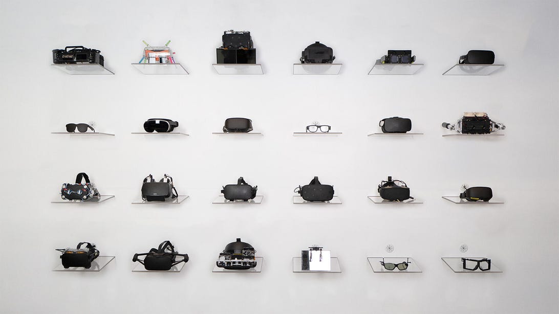 A wall of VR headset prototypes and glasses