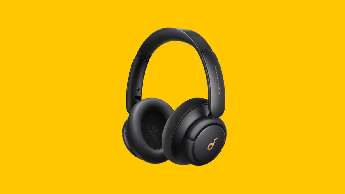 A pair of black Anker over-ear headphones against a yellow background.