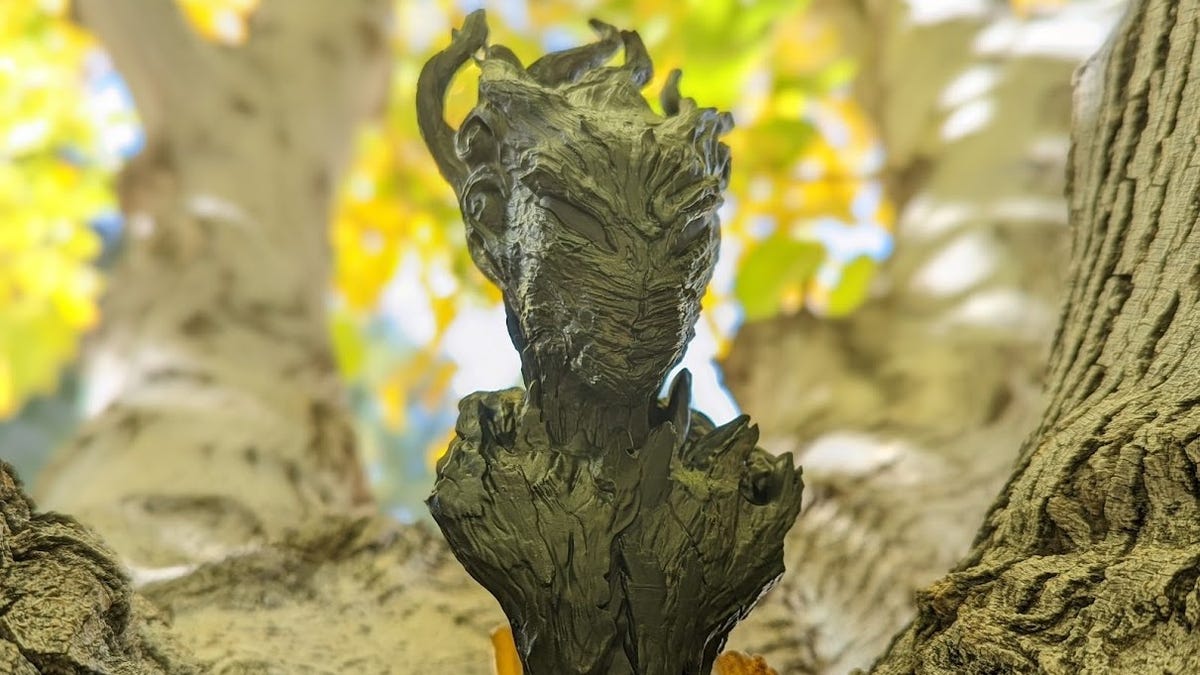 A wood dryad statue in a tree