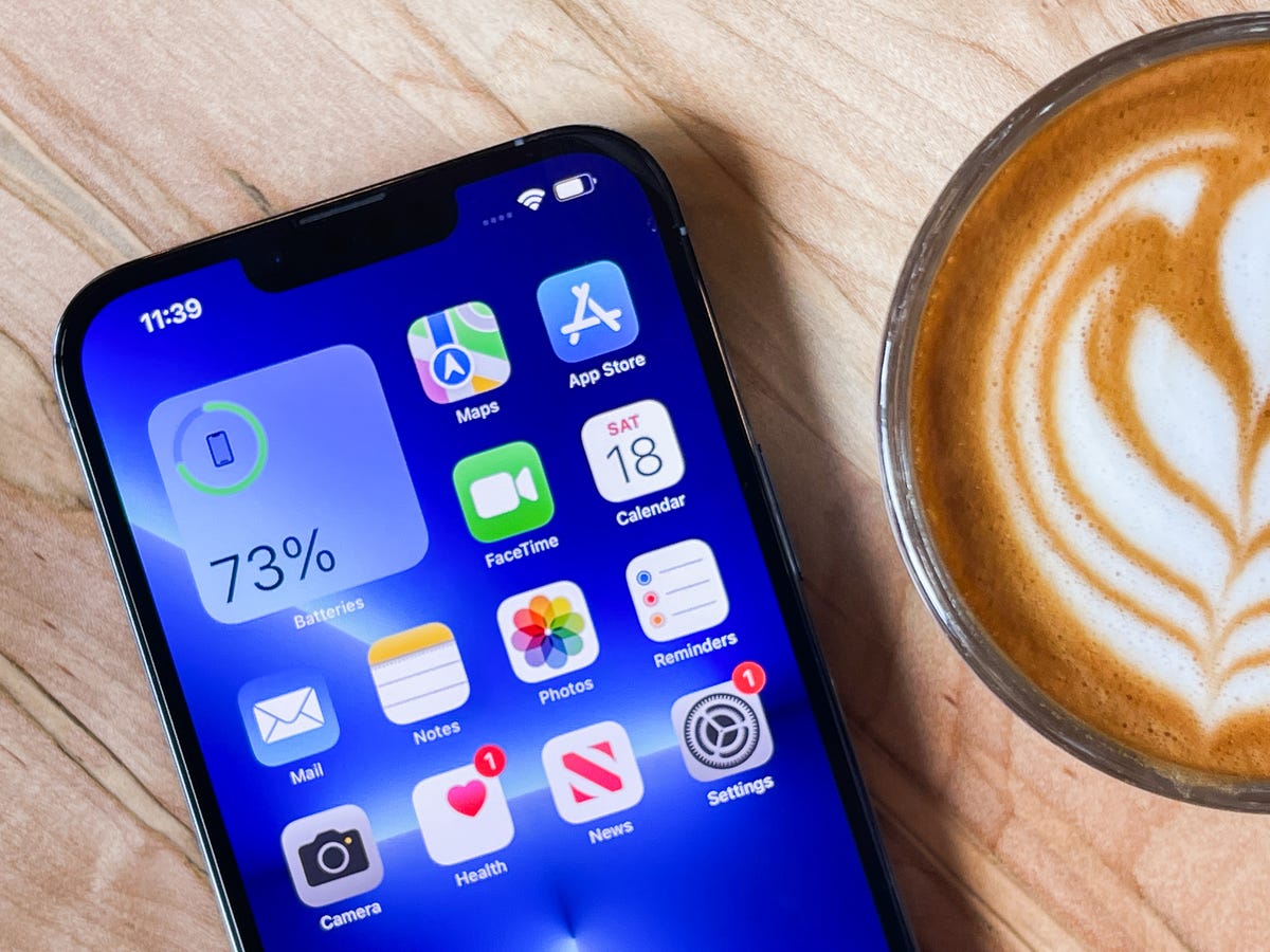 iPhone lying on a table by a latte