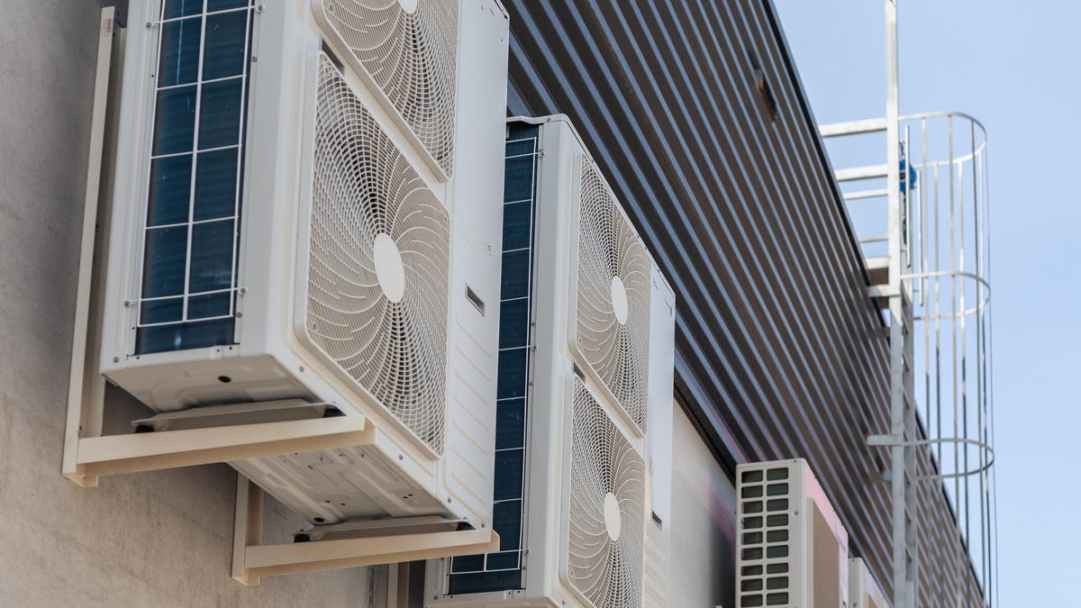 Heat pump condensers on the side of a big building.