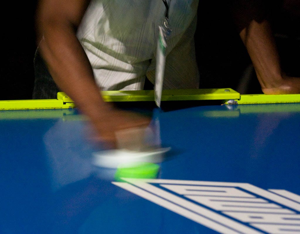 Air hockey afficionados whacked plastic pucks to their hearts' content.