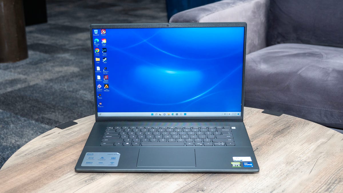 The 2022 Dell Inspiron 16 Plus sitting on a wood table.
