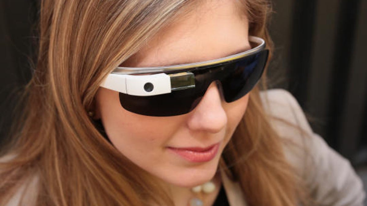 CNET&apos;s Bridget Carey tries on Google Glass with the sunglass attachment on, because the world is just too bright.