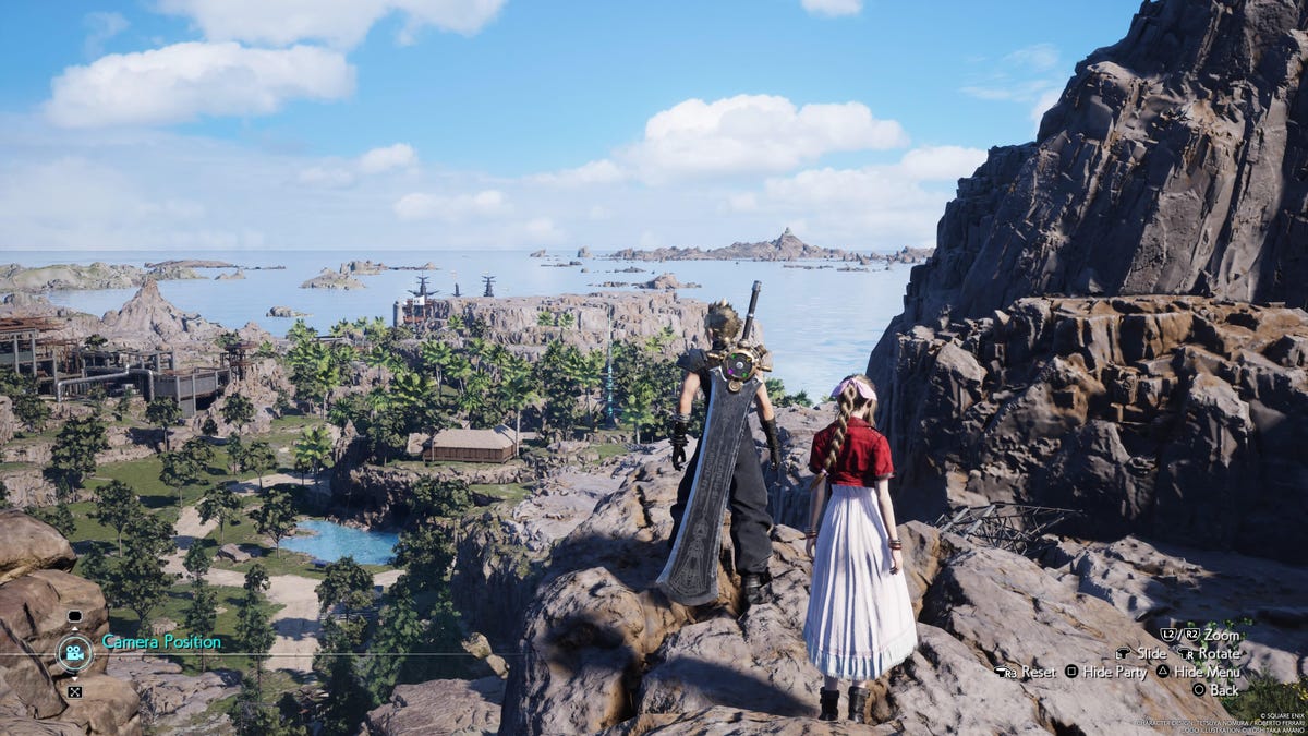 A man (Cloud) stands with a woman (Aerith) on a cliff edge overlooking the coastal area below.