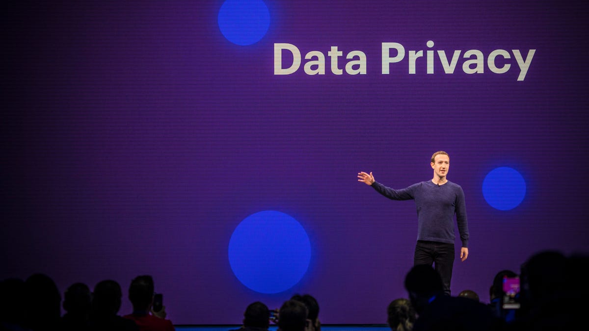 Mark Zuckerberg at Facebook's F8 conference in 2018, with a sign saying "Data Privacy"