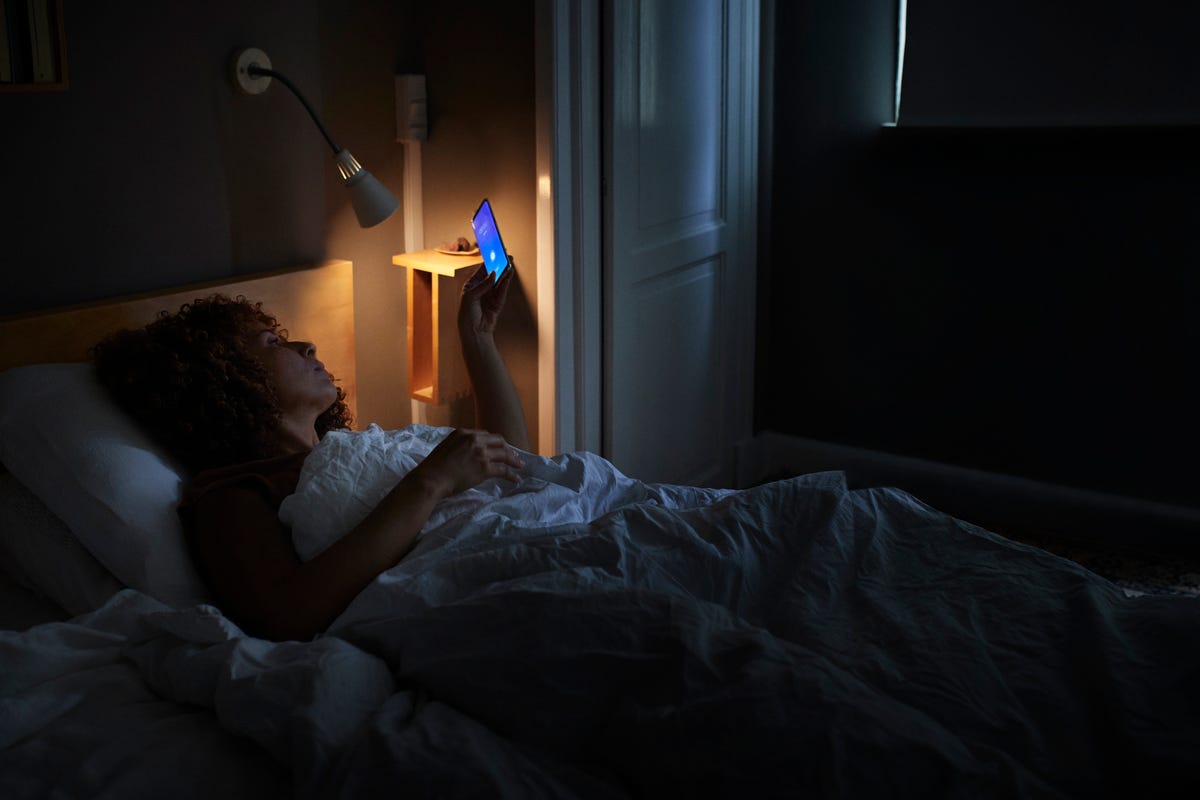 Woman turning off lights and phone
