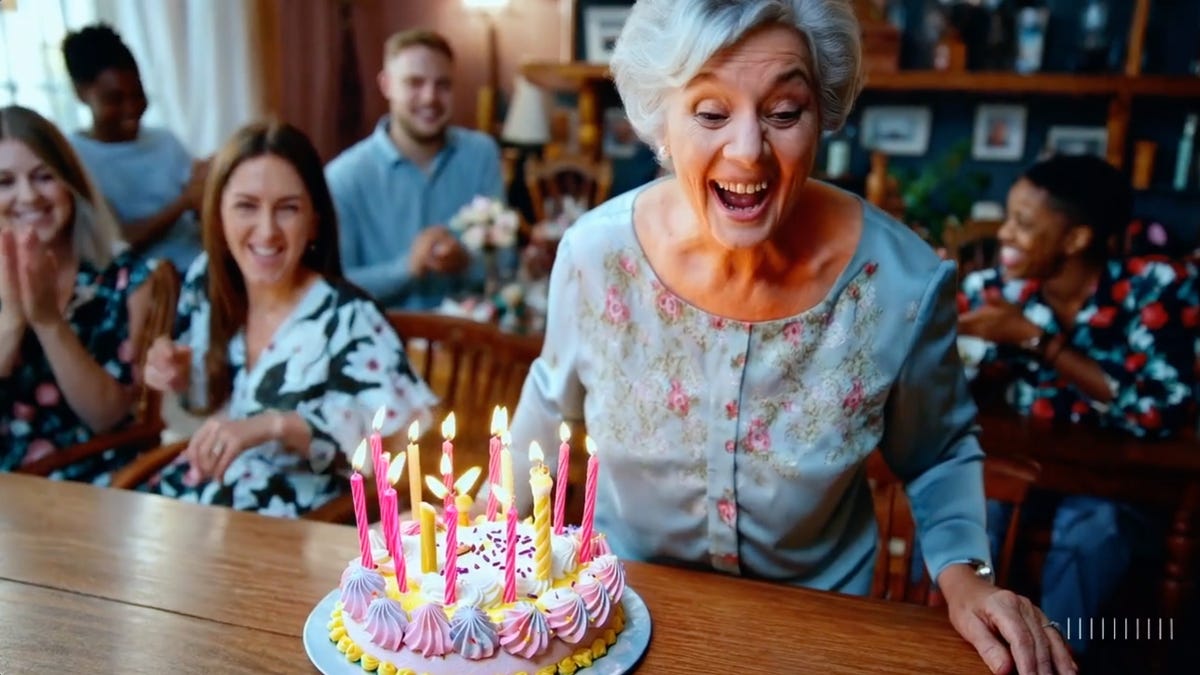 A woman prepares to blow out the candles on a birthday cake in a video generated by OpenAI&apos;s Sora.