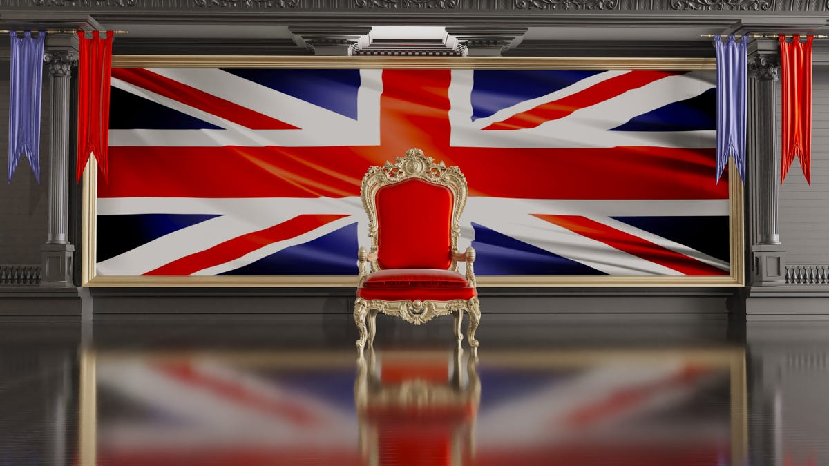 A red UK throne with the UK Union Jack flag behind it